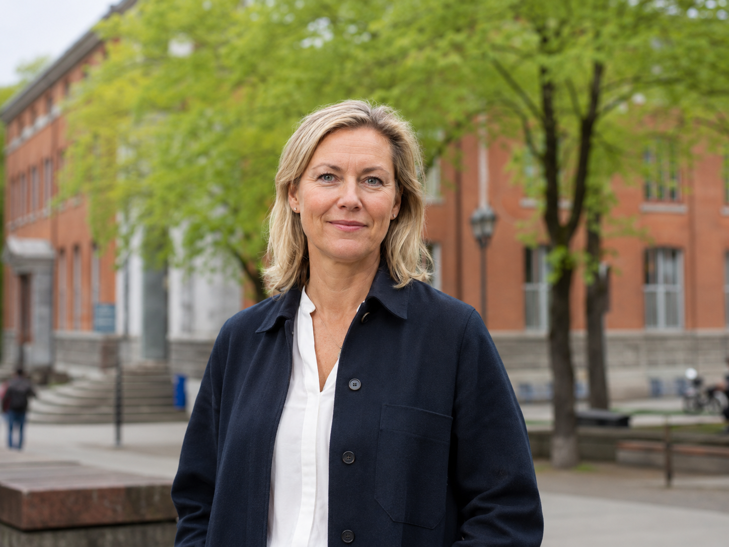 A language school director standing outside her campus building
